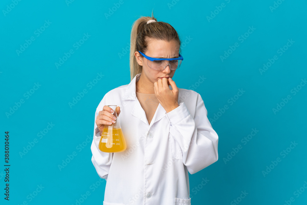Young scientific woman isolated on blue background having doubts Young scientific woman isolated on blue background having doubts