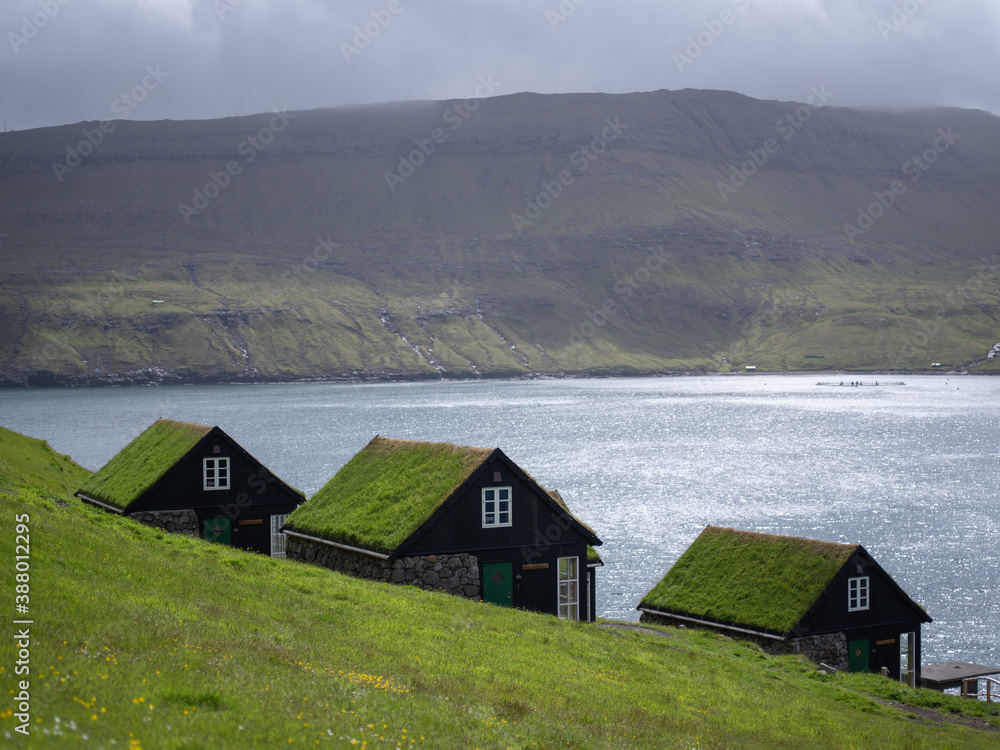 Cottages near Böur village, Vágar, Faroe Islands. The cottages are built with inspiration from the old traditional Faroese houses. Stone foundation, white window bars and grass on the roof.