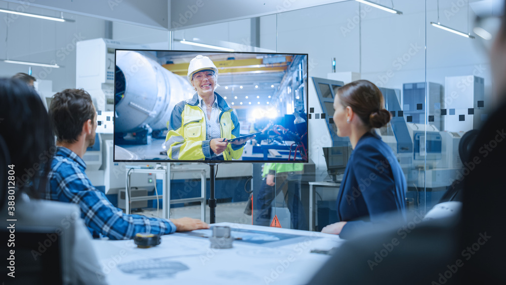 Diverse Group of Specialists, Managers in the Factory Office Meeting Room, Have Conference Video Call with Factory Chief Female Engineer, She Talks about Production Growth, Uses Tablet Computer