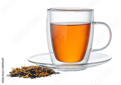 Glass cup of tea with dry tea leaves isolated on white