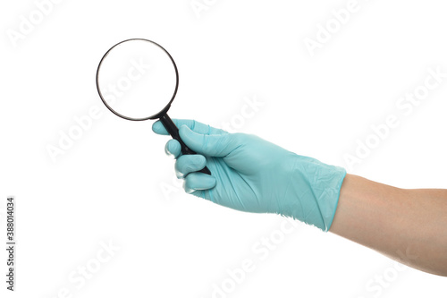 Man's hand holding magnifying glass, close up isolated on white background, copy space for your text. Magnifier for reading