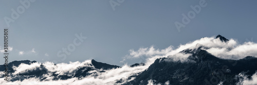 Panorama of mountain range with fog and billowing clouds in Austria photo