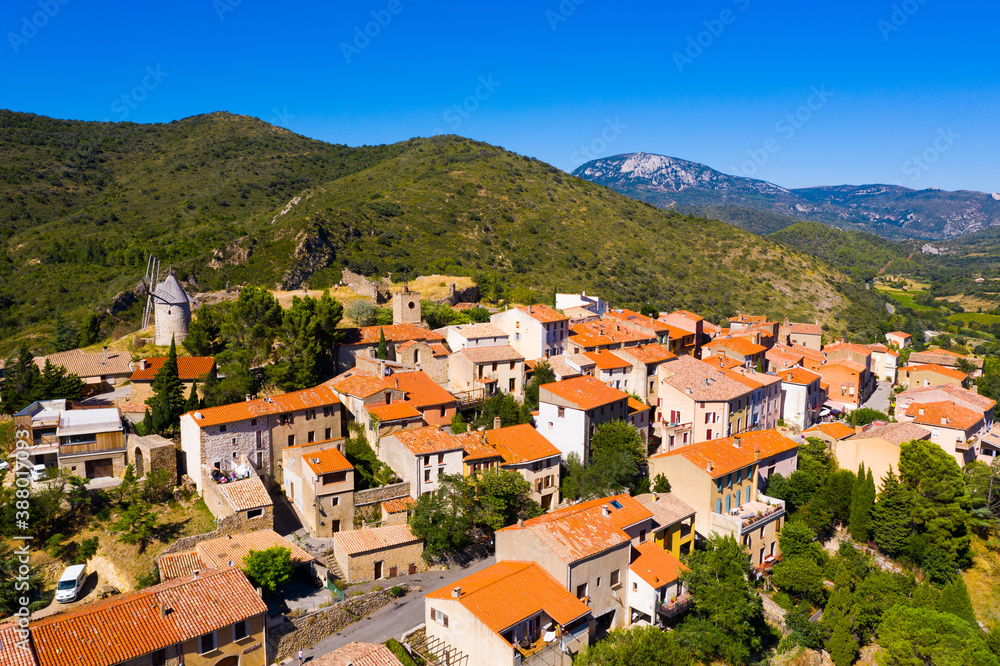 Picturesque aerial view of Cucugnan commune with main landmark 17th-century windmill, Aude department, southern France