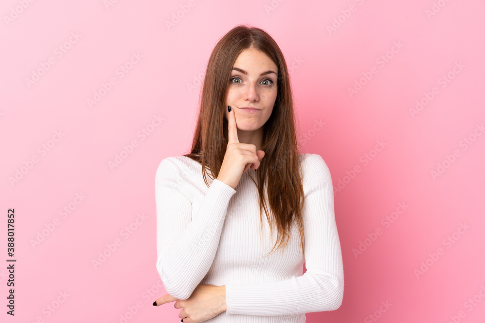 Young woman over isolated pink background Looking front Young woman over isolated pink background Looking front