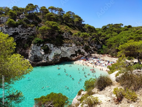Cala Macarelleta famous paradise beach with turquoise water and pine forests on south coast of Menorca Island, Balearic Islands, Spain. © Mateusz Misztal