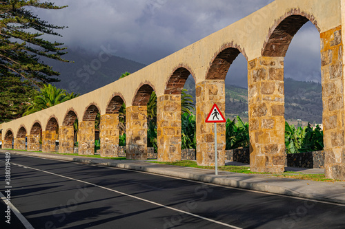 Los LLanos de Aridane aqueduct, with sunlight and grey clouds background, La Palma islands, Canary islands, Spain photo