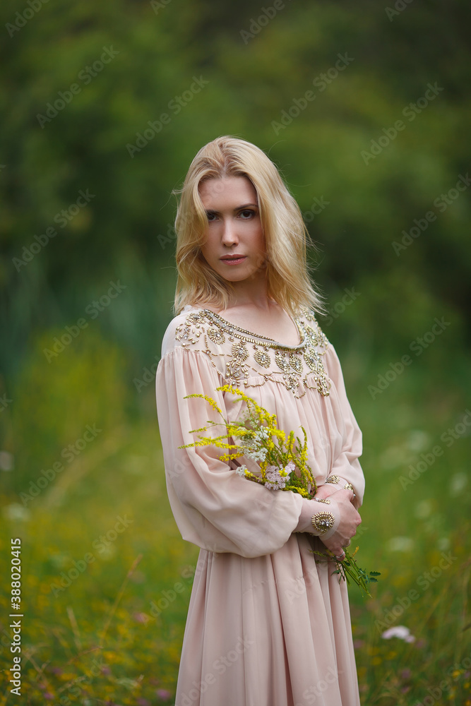 beautiful girl walking in a blooming field beautiful girl walking in a blooming field