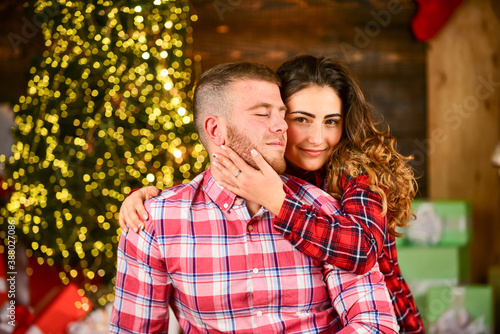 Holiday mood. Happy woman and man. Celebrate new year at home. Spread love. Holiday gift. Couple in love making surprise for each other. True love. Happiness and joy. Best holiday. Christmas time