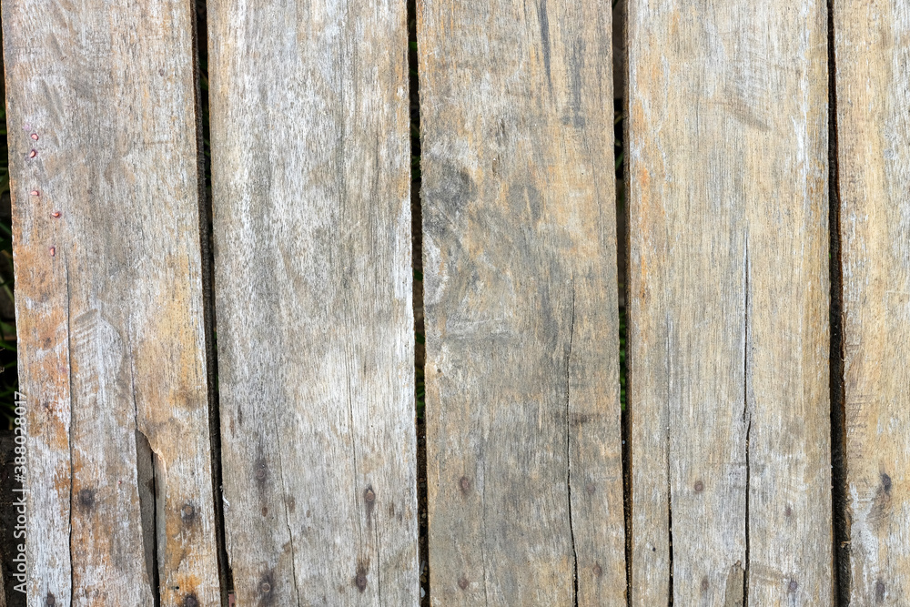 Part of an old fence. dry wooden boards. Old nails left rust on wood. Grunge wooden fence wall background texture