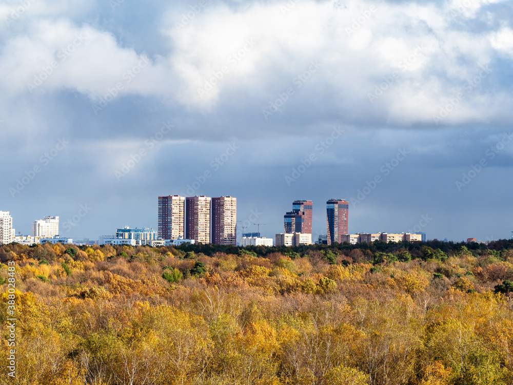 sky with rainy clouds over yellow forest and residential district on horizon on sunny autumn day sky with rainy clouds over yellow forest and residential district on horizon on sunny autumn day