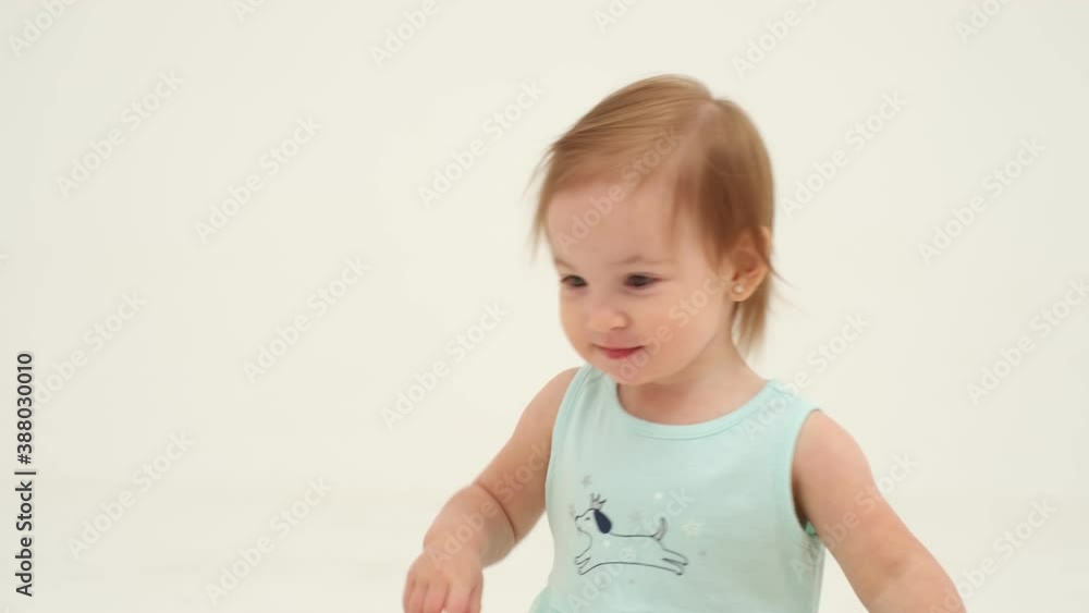 Happy little girl in mint dress is playing toys. Slow motion Happy little girl in mint dress is playing toys. Slow motion