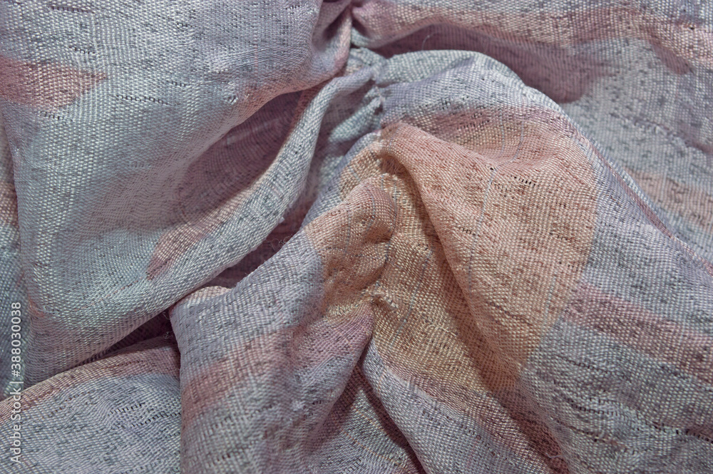 Φωτογραφία The texture of silk fabric gathered in folds of gray-pink color