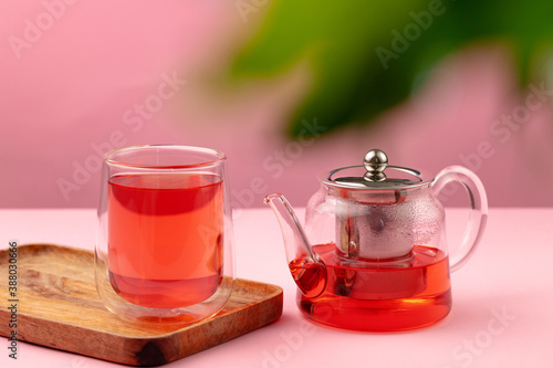 Glass teapot and cup with black tea