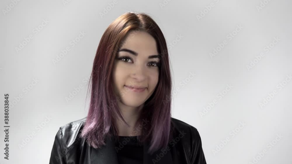 Portrait of a caucasian woman who agrees and nods on the white background. Young pretty lady is listening and accepting an offer. She is a little hesitating and flirting. Concept of person's emotions. Portrait of a caucasian woman who agrees and nods on the white background. Young pretty lady is listening and accepting an offer. She is a little hesitating and flirting. Concept of person's emotions.