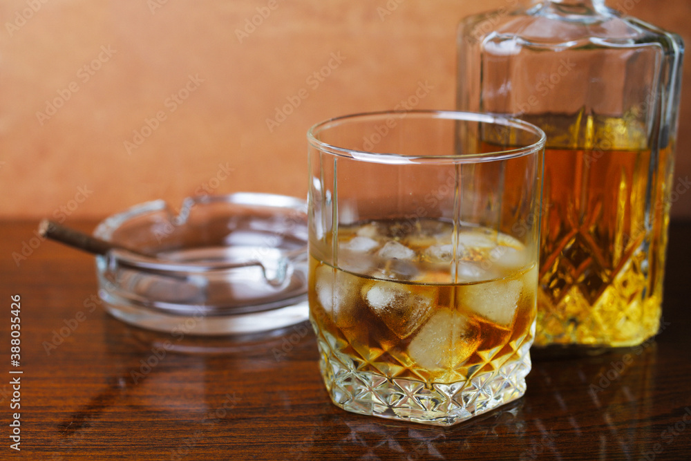 Whiskey with ice on a wooden table close-up, place for your text. Whiskey with ice on a wooden table close-up, place for your text.