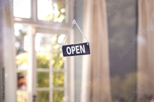 Open Sign Hanging In Shop Window During Health Pandemic