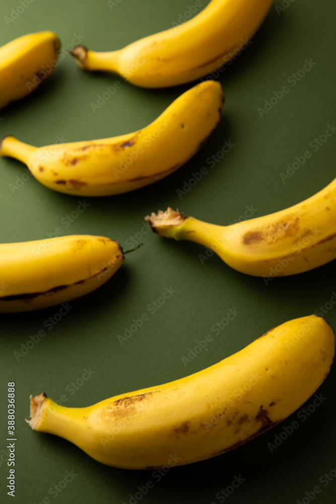 yellow banana on dark green background yellow banana on dark green background