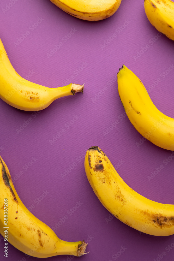 yellow banana on violet background yellow banana on violet background