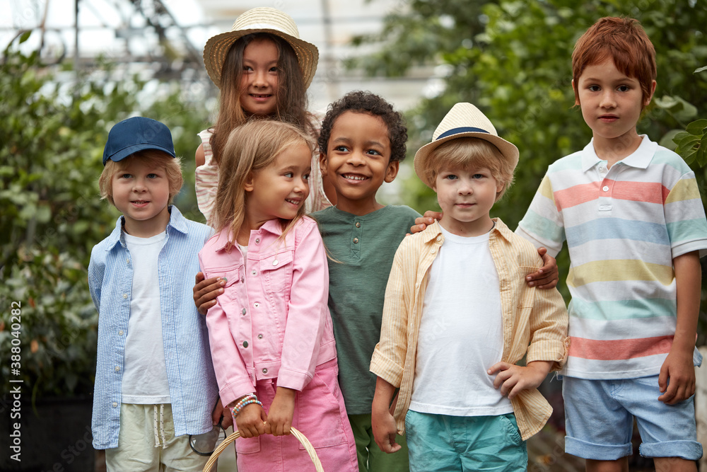 portrait of friendly kids group in lemonarium or greenhouse, they learn environment and nature, green plants around them portrait of friendly kids group in lemonarium or greenhouse, they learn environment and nature, green plants around them