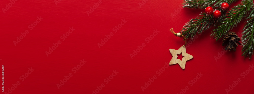 Wooden Christmas tree toy in the form of a star on a red background.