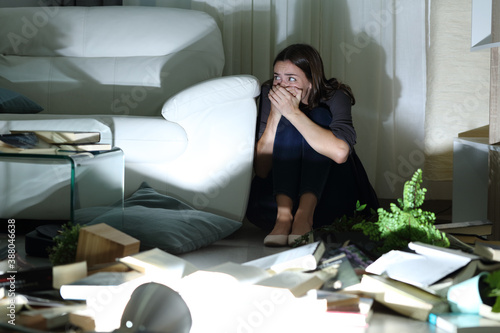 Obraz na plátne Scared woman hiding from intruder during home robbery