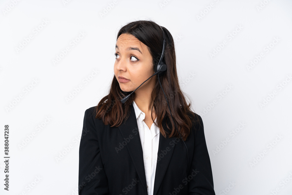 Young telemarketer woman isolated on white background making doubts gesture looking side Young telemarketer woman isolated on white background making doubts gesture looking side