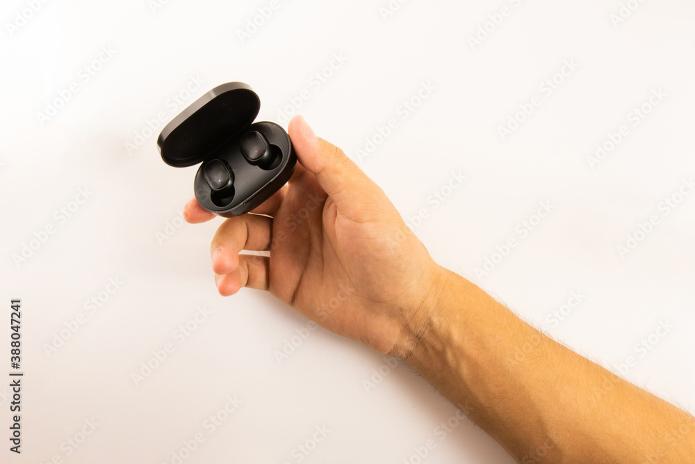 Wireless headphones in hand on a white background