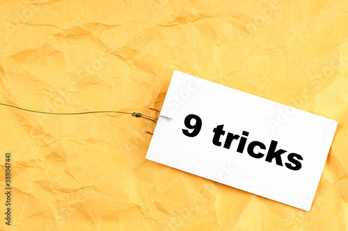fishhook paper with 9 tricks written on it
