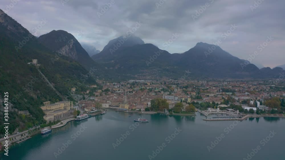 Aerial shot of passenger boat pulling out of the Riva Del Garda marina, Italy Aerial shot of passenger boat pulling out of the Riva Del Garda marina, Italy