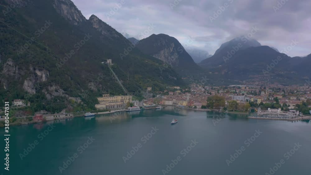 Dolly in aerial shot approaching a passenger boat just leaving a beautiful, scenic place Dolly in aerial shot approaching a passenger boat just leaving a beautiful, scenic place