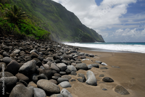 Black sand beach and Pali sea cliffs at Kalaupapa leper colony photo