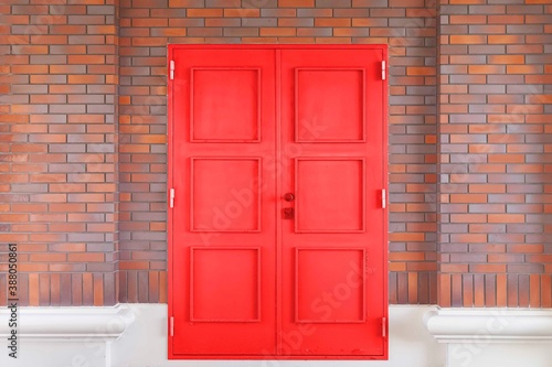 Antique red iron gate and red brick wall