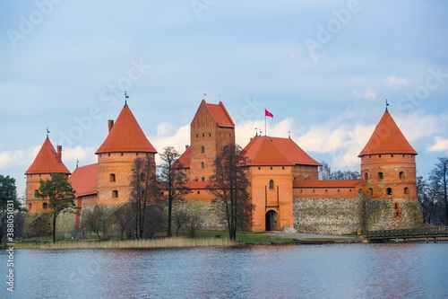 Trakai Island Castle in Lithuania. Panoramic view of the Lake Galve, blue sky and red brick towers. European castle, landmark of the Baltic region