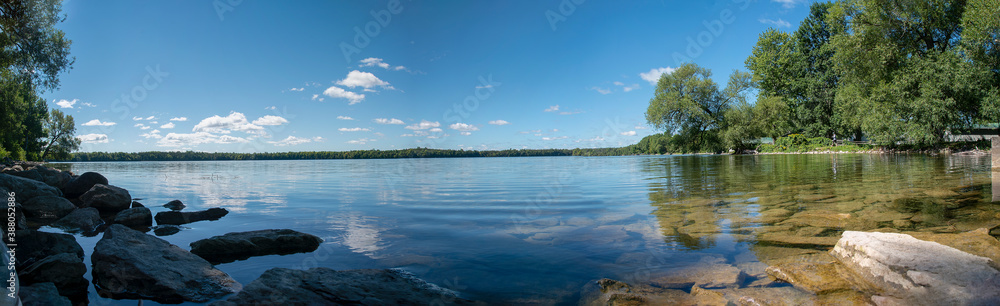 A panoramic view of the crystal clear waters of Lake on a Mountain near Picton in Prince Edward County, Ontario as they glisten in the morning sun on a beautiful late summer day.