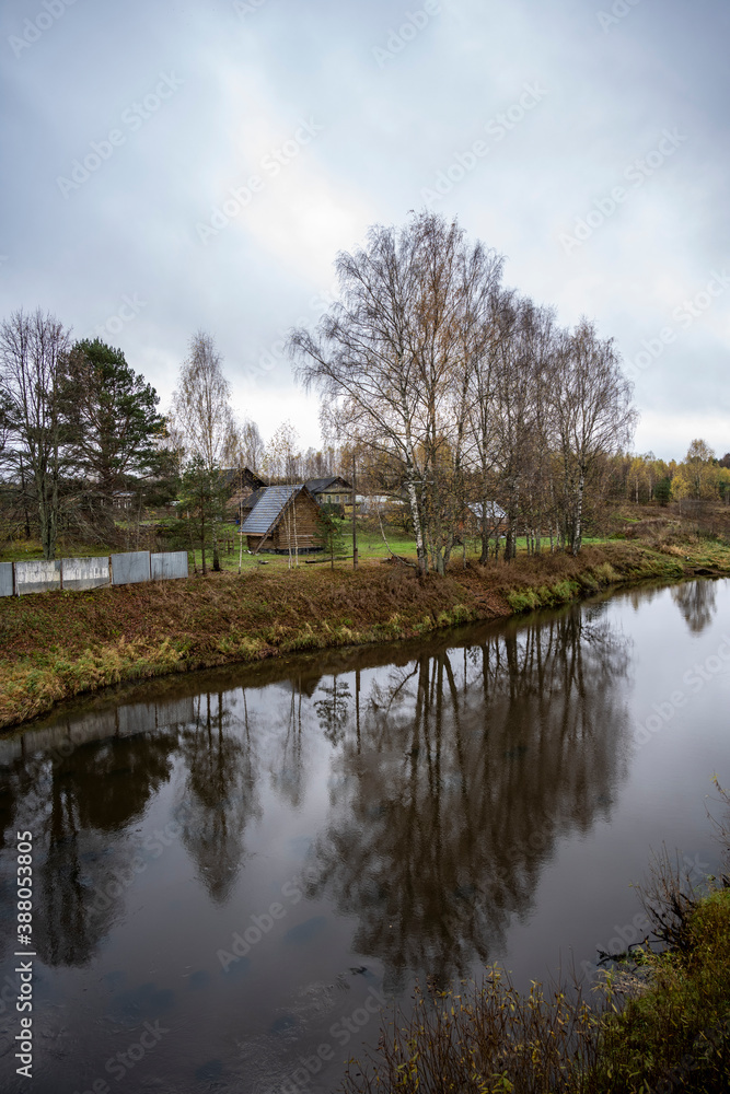 autumn yellow rural landscape with wooden houses and a river autumn yellow rural landscape with wooden houses and a river