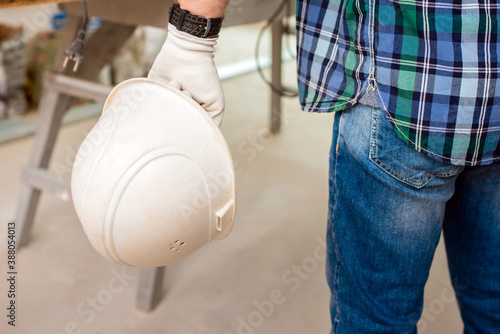 protective helmet in the hand of a worker