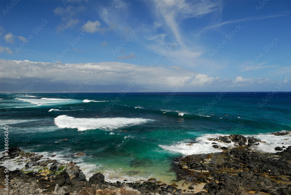 Group of surfers with long waves at Hookipa Beach Maui