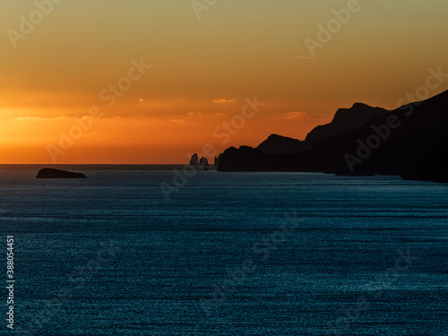 Spectacular sunset view from the Amalfi coast, Italy in the Mediterranean sea with islands in silhouette
