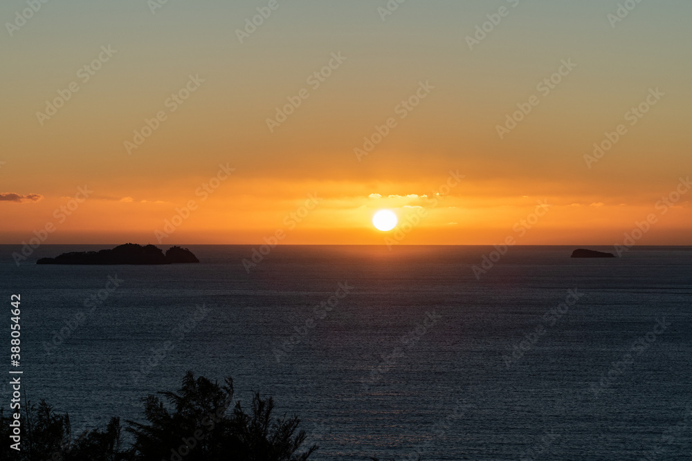 Spectacular view of golden sunset from the Amalfi coast, Italy in the mediterranean sea with islands in silhouette