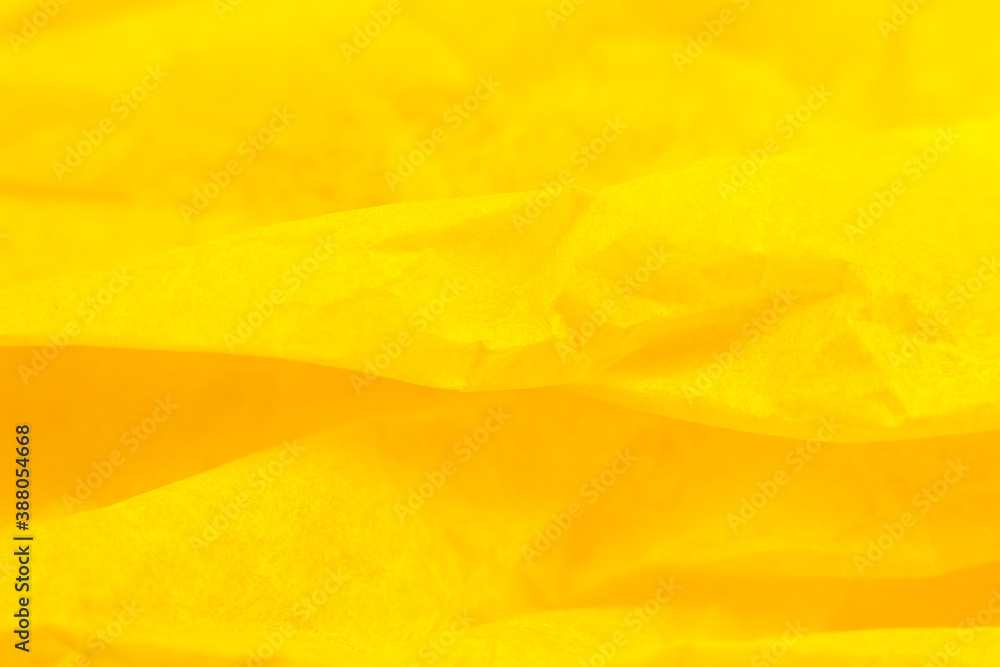 Fototapeta premium Crumpled yellow paper background. Real macro battered texture. Close up photo.