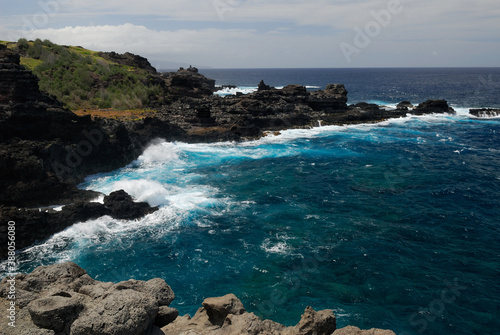 Lava rocks shore and crashing waves at Mokolea Point Maui