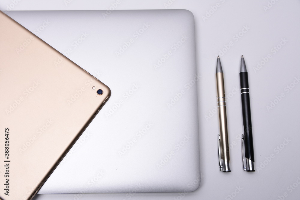 Business place with laptop, pad and pen Business place with laptop, pad and pen