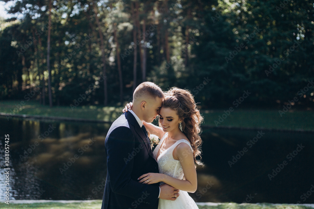 Naklejka premium Walk of the bride and groom in the summer garden.