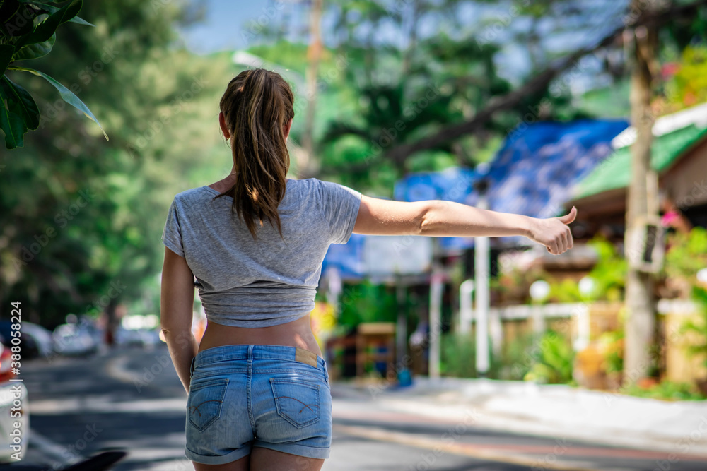Pretty girl in shorts tries to catch a car Pretty girl in shorts tries to catch a car
