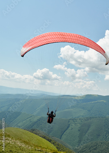 Paraglider is flying in the sky.