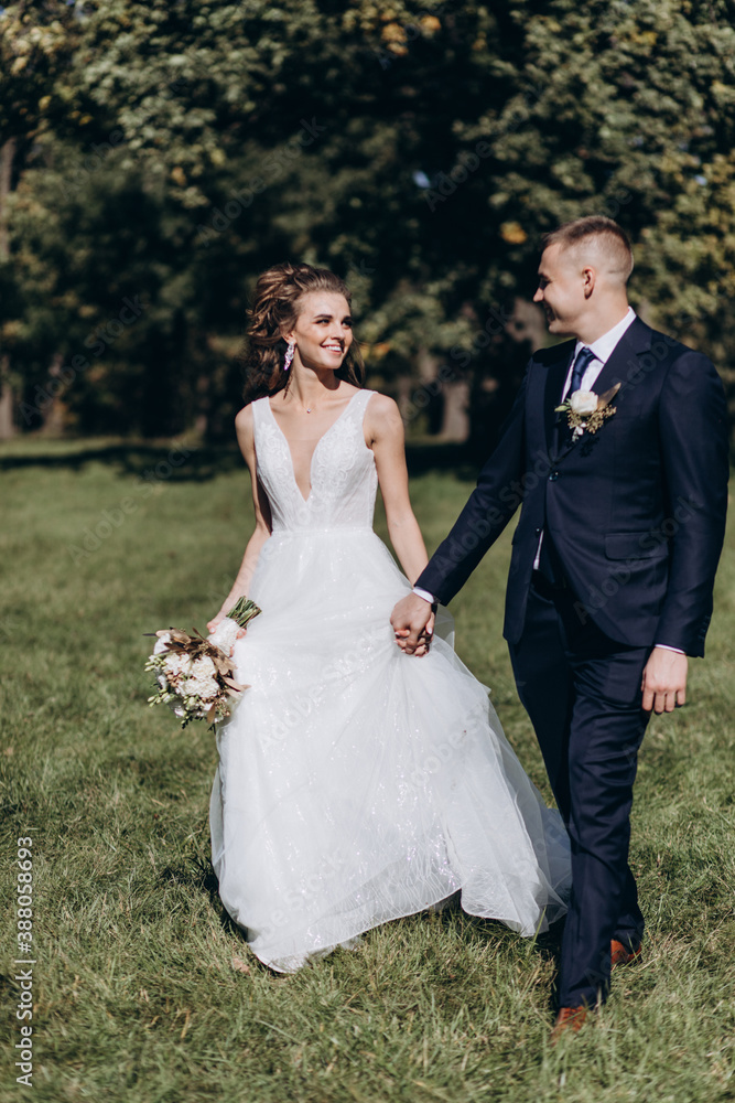 Walk of the bride and groom in the summer garden. Walk of the bride and groom in the summer garden.