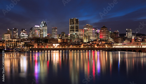 Montreal skyline illuminated at night with nice reflections in Saint Lawrence River  Quebec  Canada