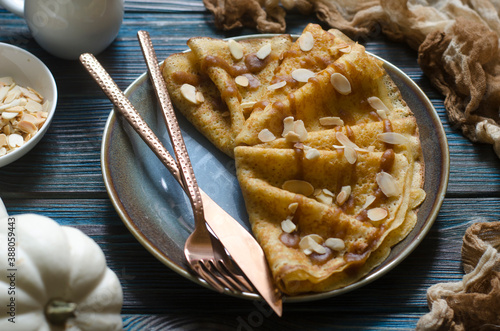 Pumpkin pancakes with date syrup and almonds