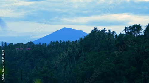 Moung Agung volcano in Bali at sunrise, view across jungle photo