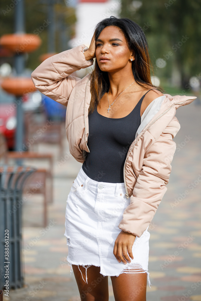 Young multiracial woman posing outdoor on fall day